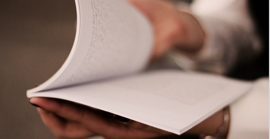 Close crop of a person holding open a notebook